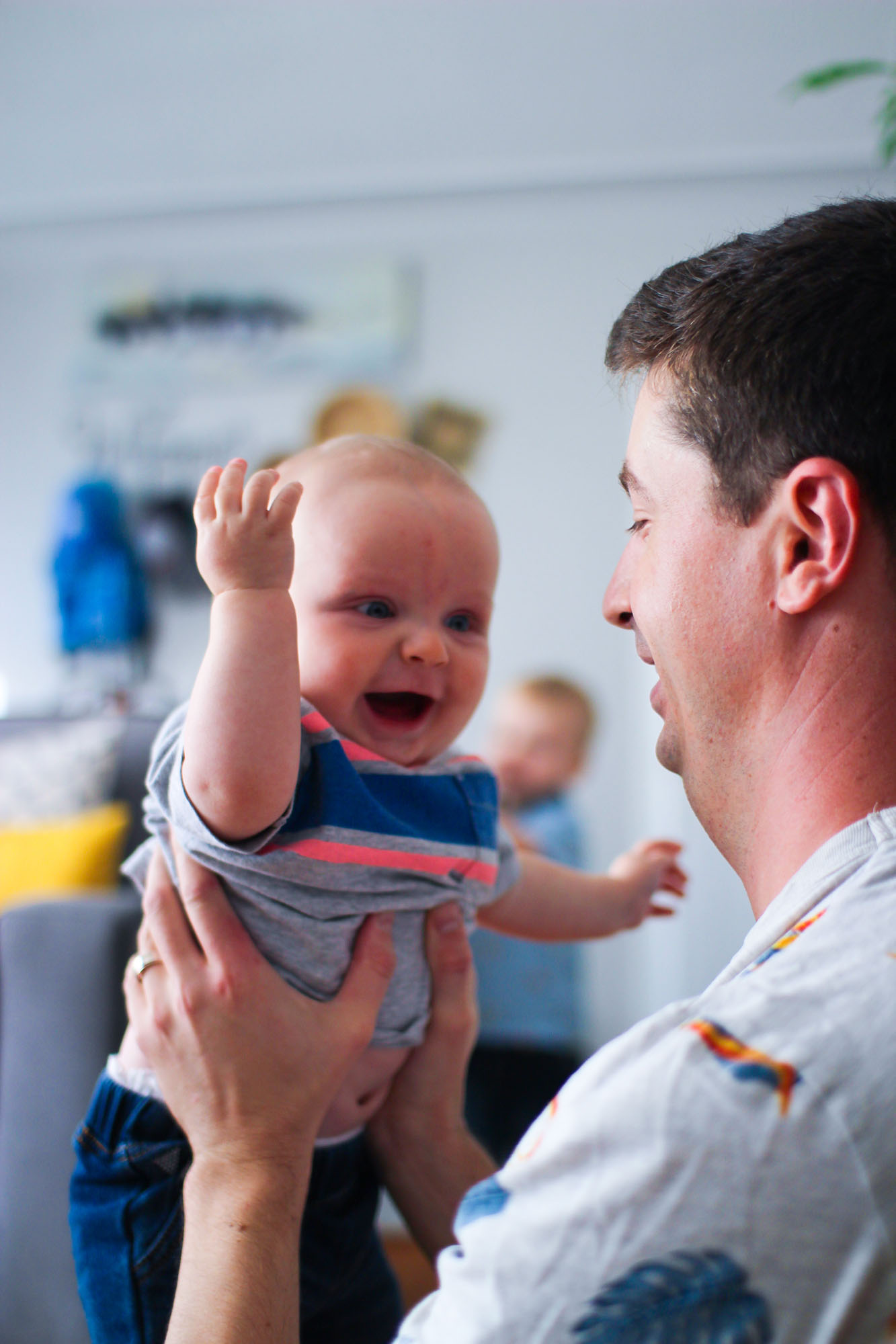 happy baby held by father