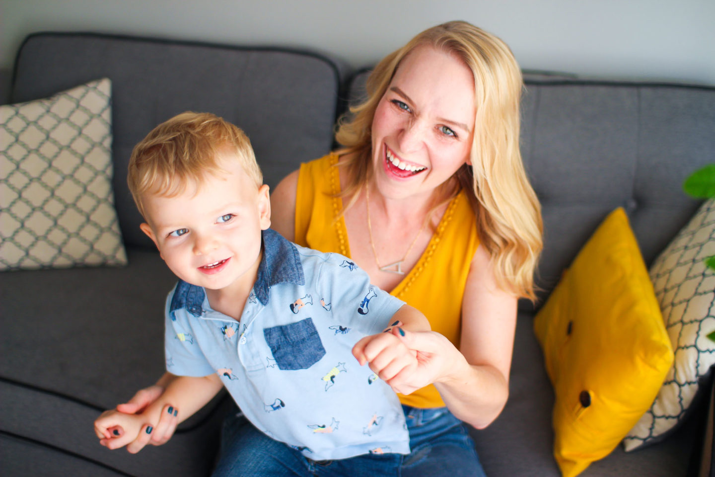 mom and toddler son playing on couch