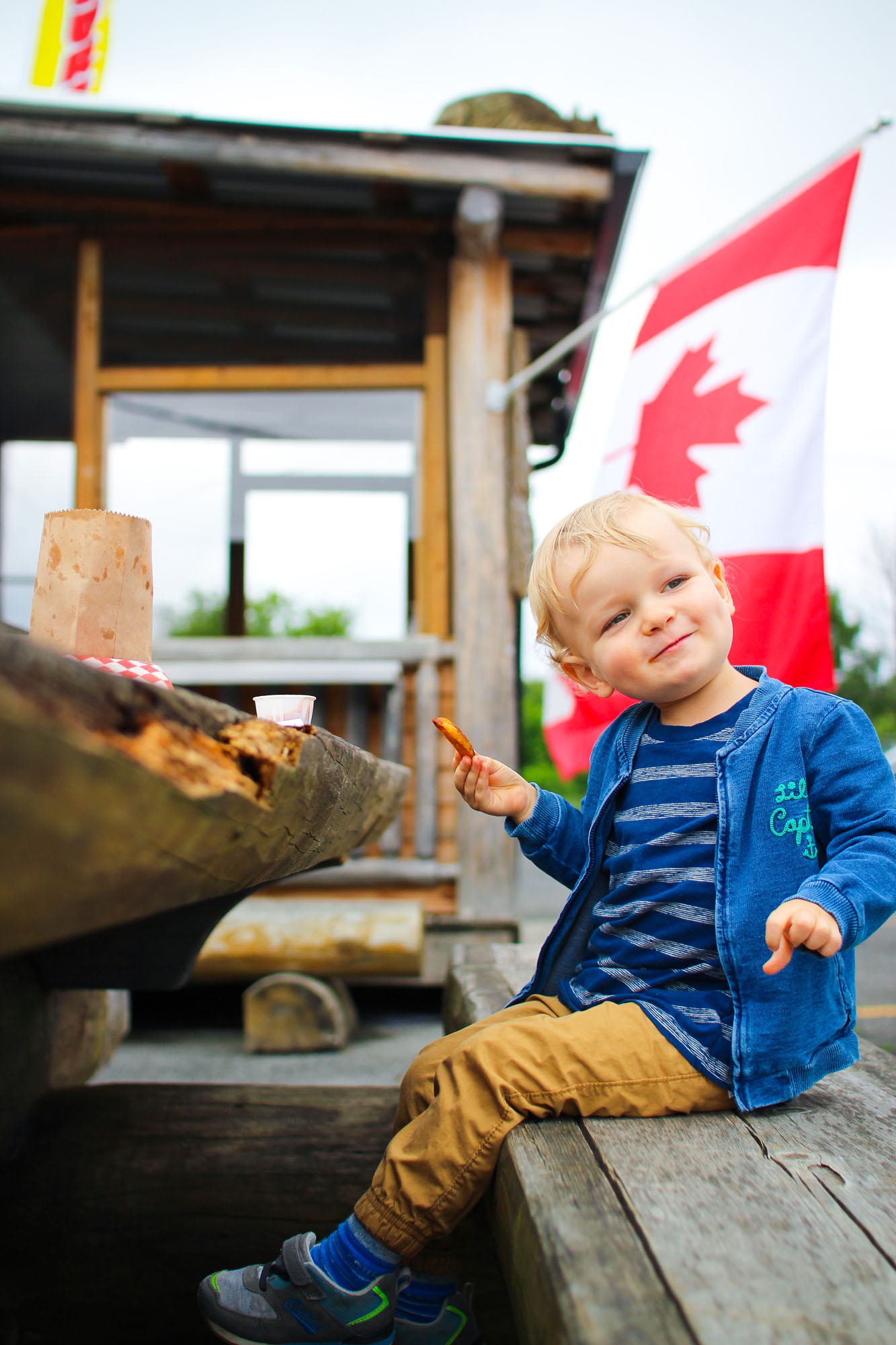 little boy eating french fries at the great canadian chip hut