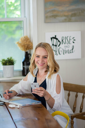 woman looking at camera while working at table