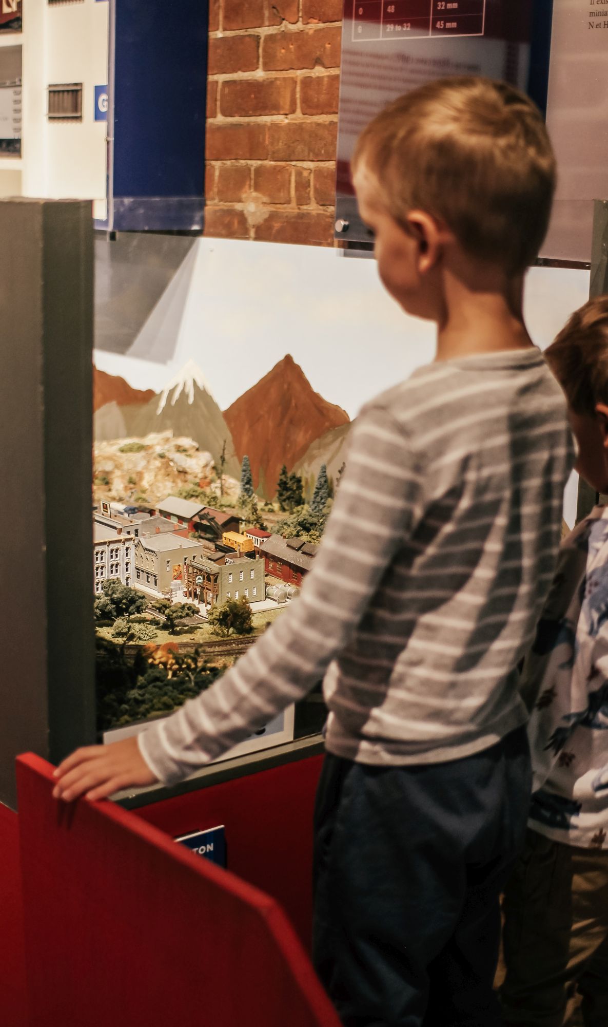 children watching model trains at the swyrich train room 
