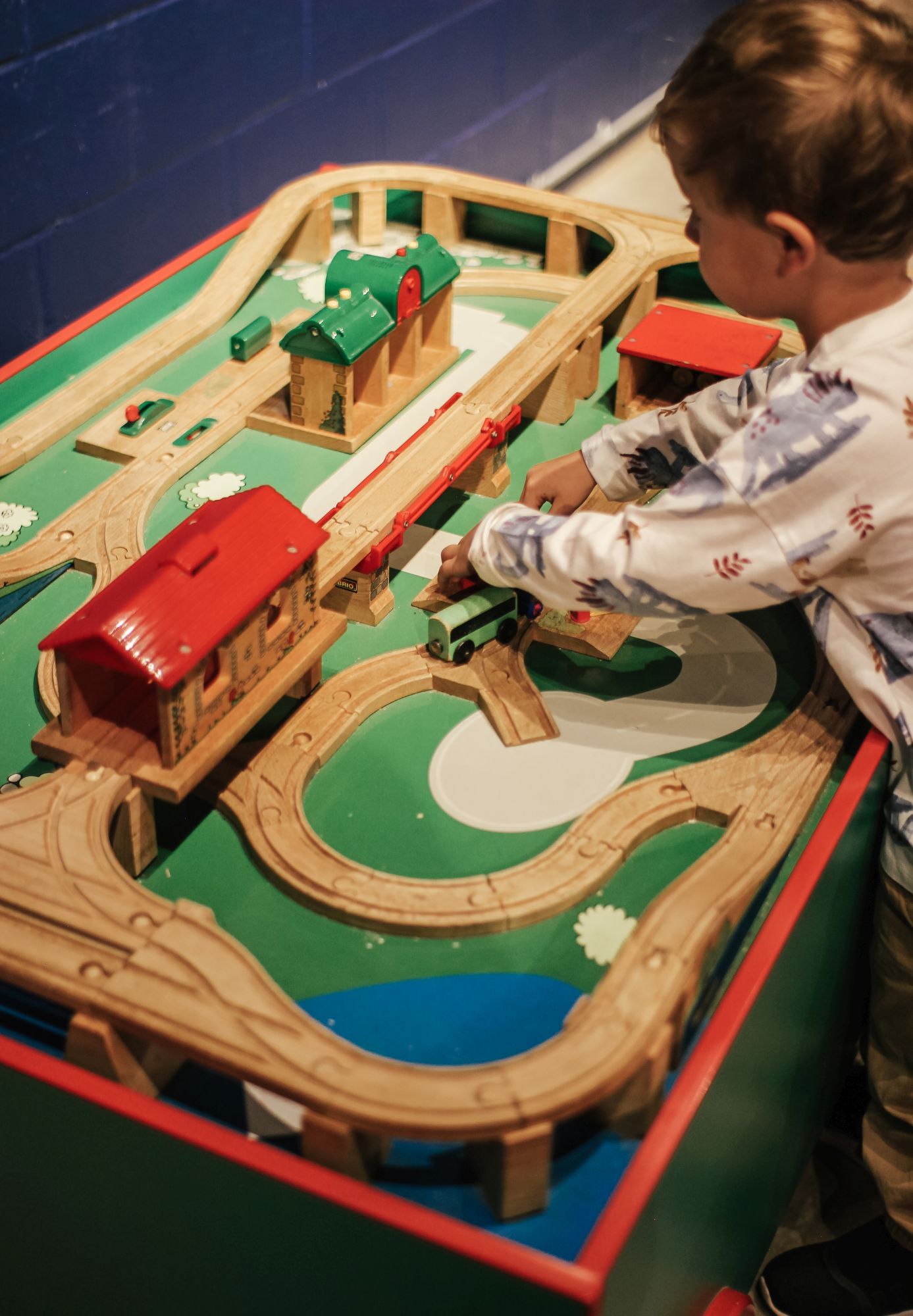 little hands playing with trains at the swyrich train room pumphouse museum