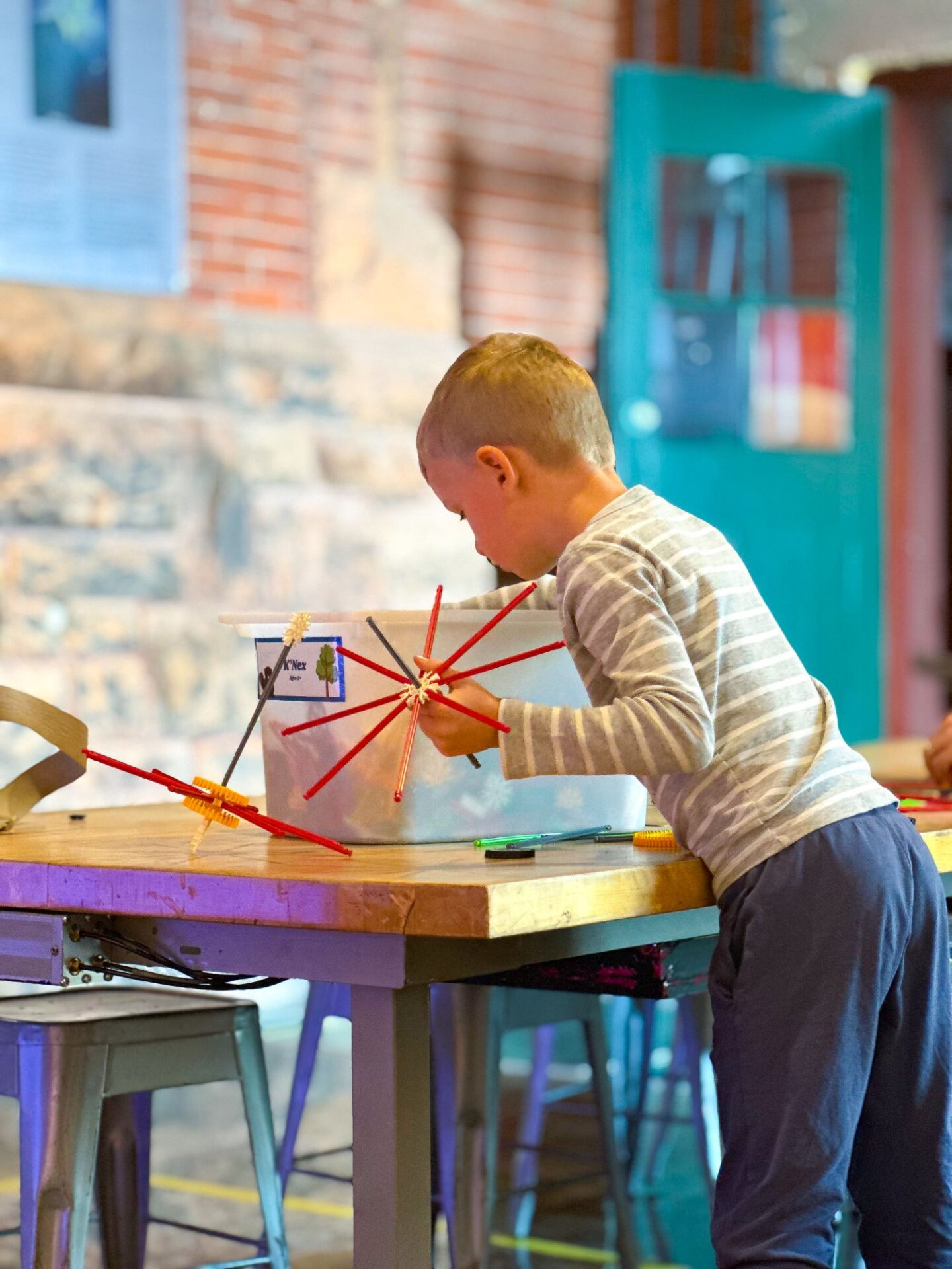little boy playing with toys at the discover centre 