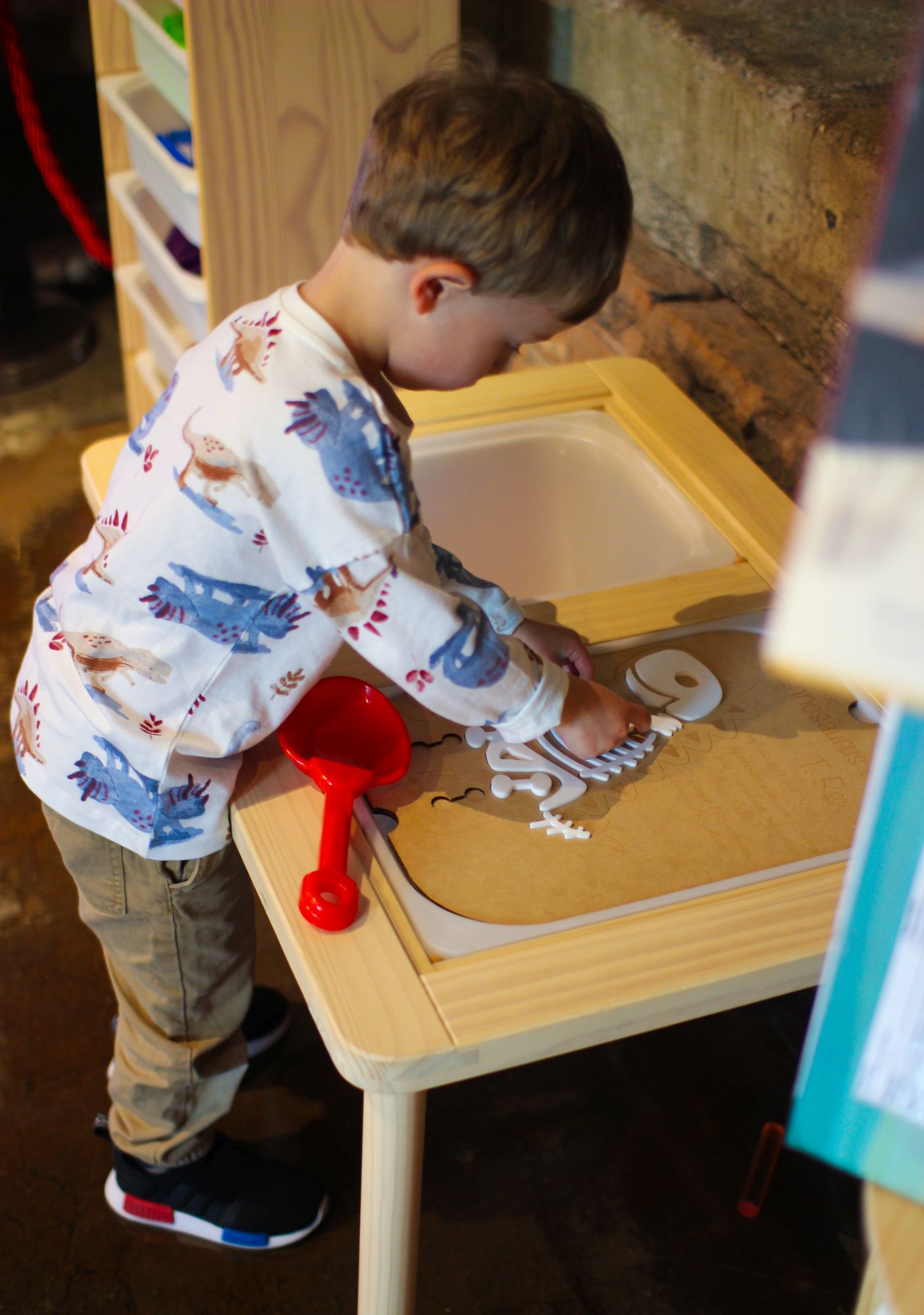 little boy working on a dinosaur puzzle at the pumphouse museum discovery centre